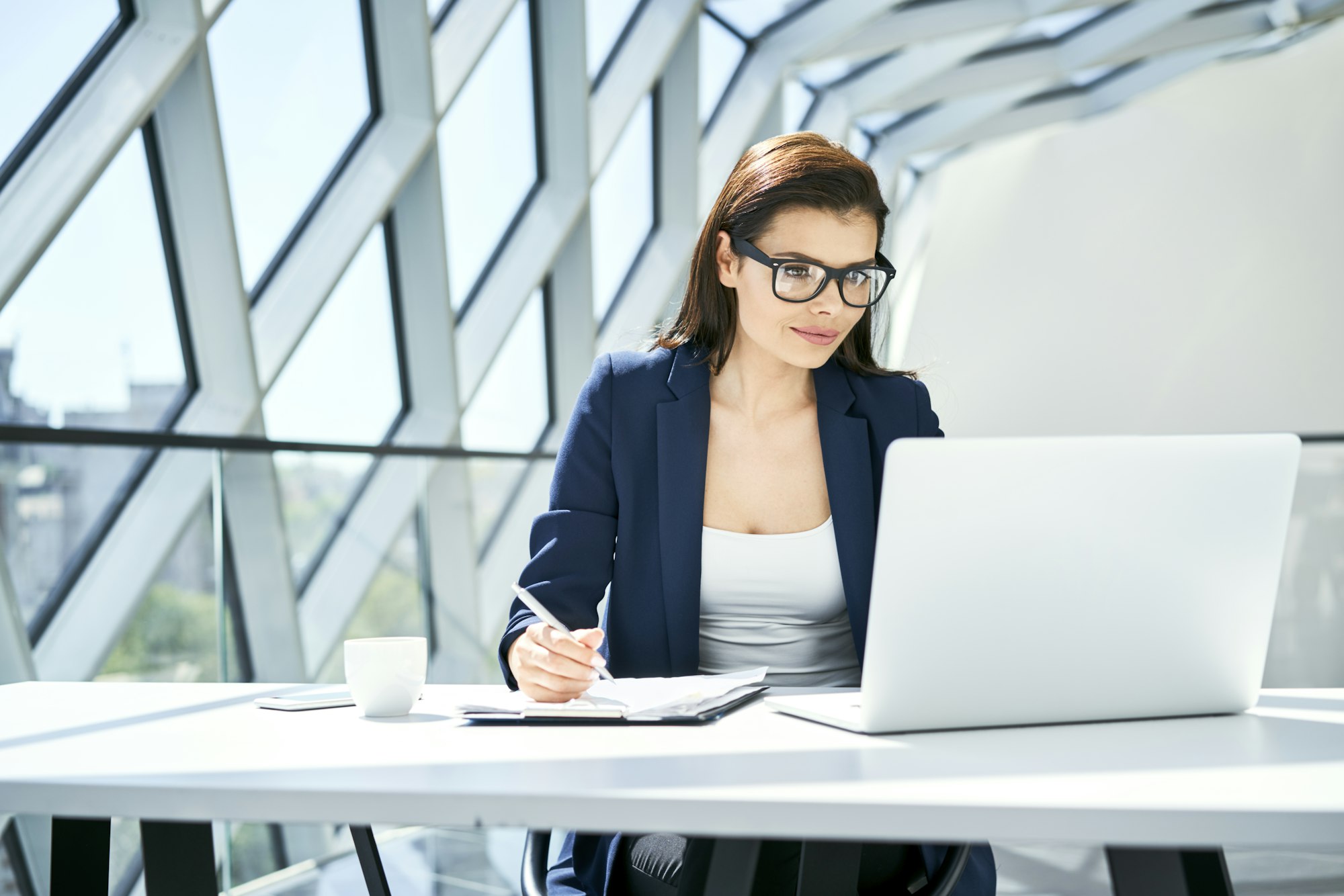 Businesswoman working at desk in modern office